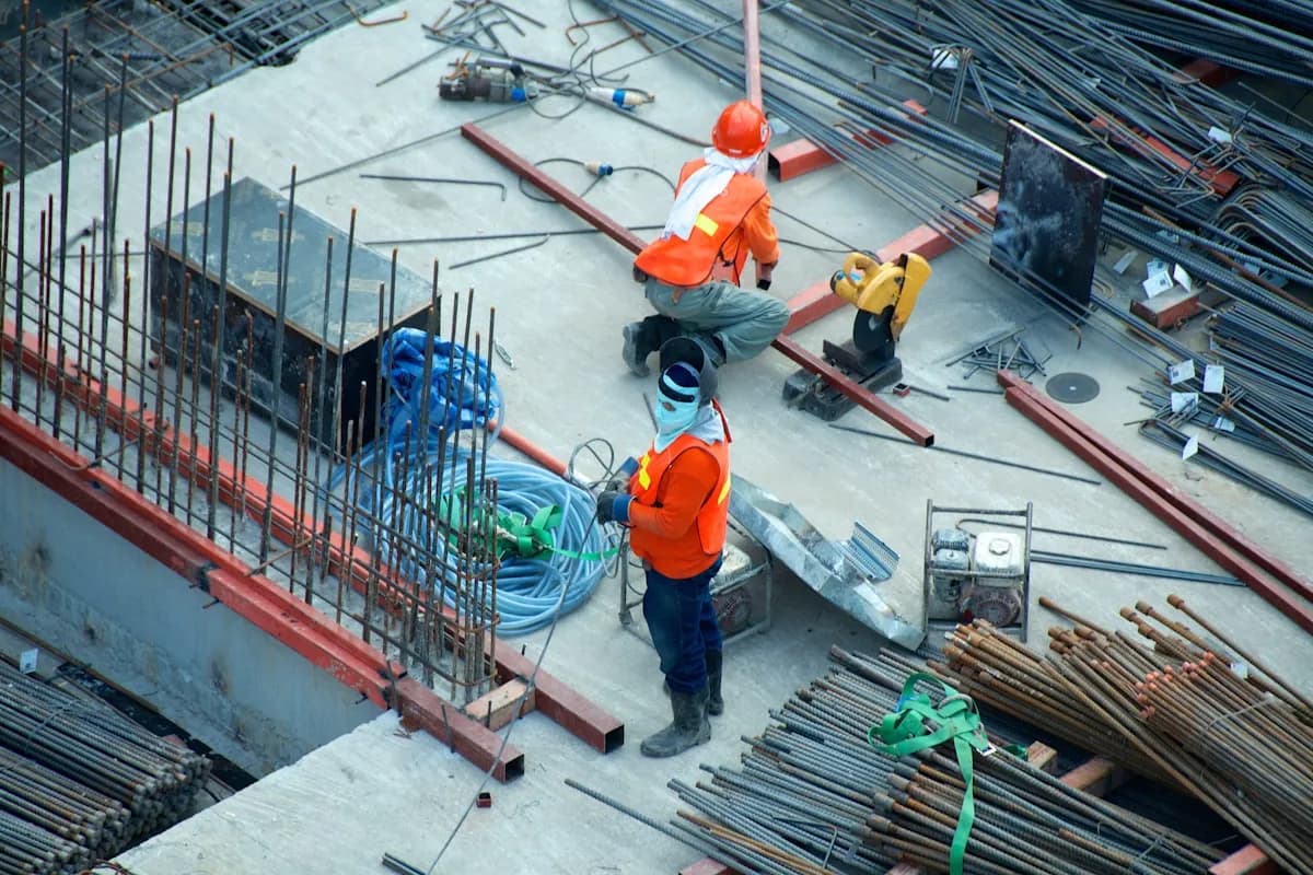Site manager using construction app on smartphone at UK building site
