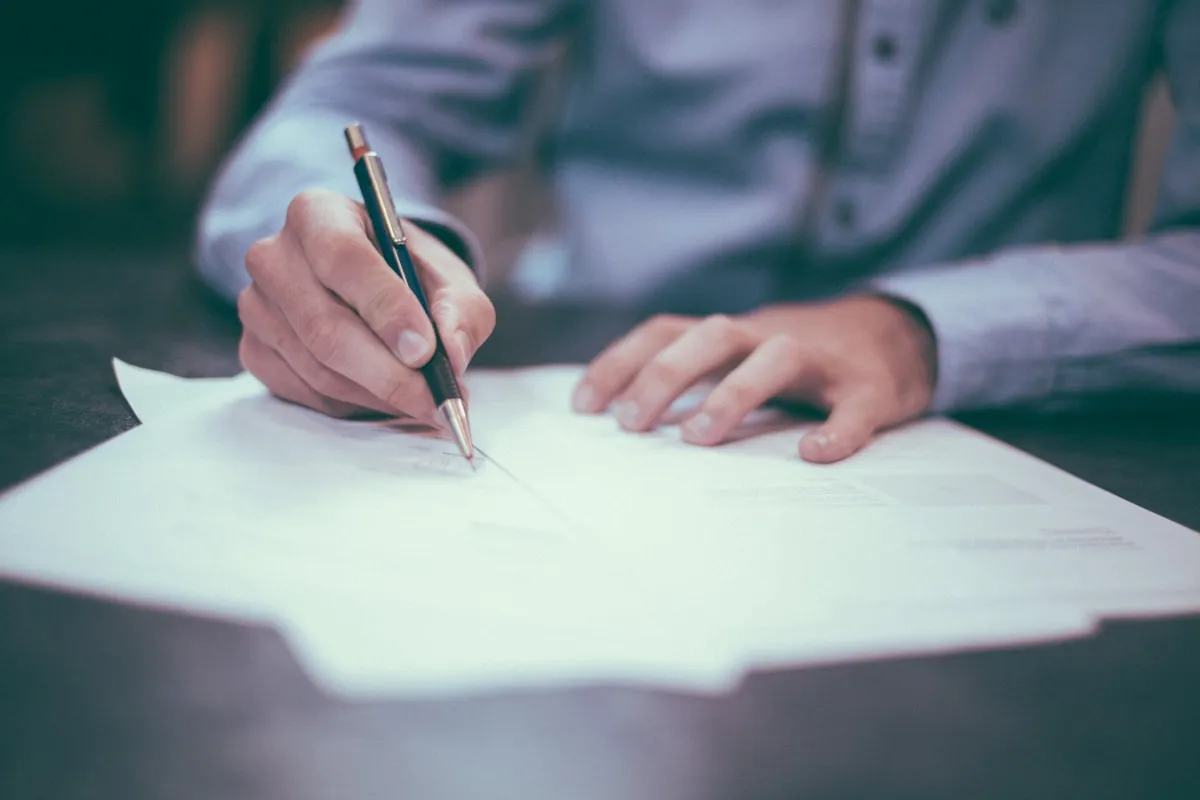 Contractor reviewing CIS deduction paperwork and HMRC documentation